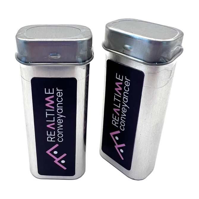A silver tin with a hinged lid, featuring a black label and logo, showcasing a sleek, modern design.