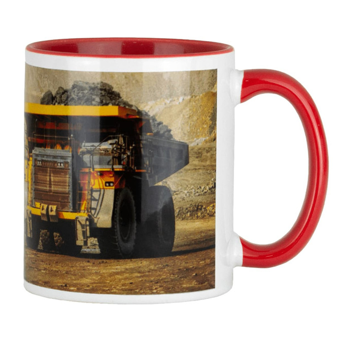 A ceramic mug featuring a red handle and interior, displaying an image of a mining dump truck.
