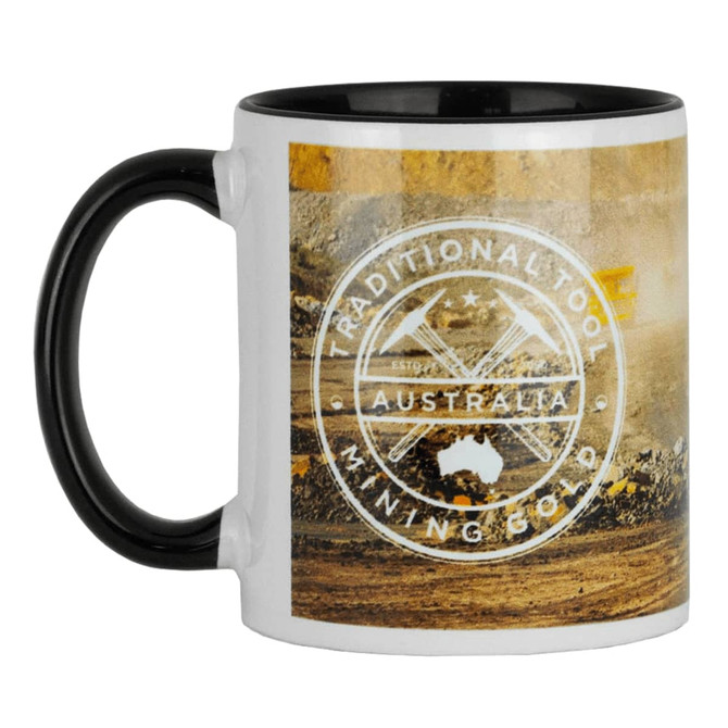 A two-tone ceramic mug featuring a black handle and interior, displaying a mining scene and a logo.