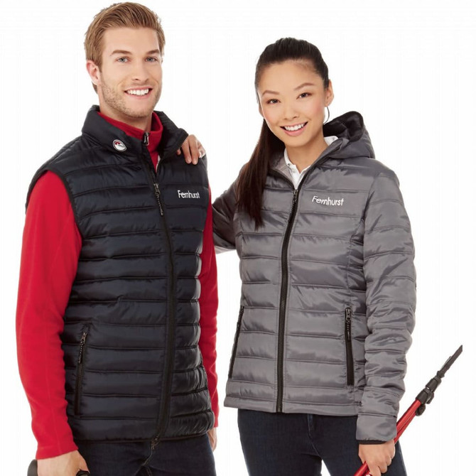 A puffer jacket for women in grey, featuring a fitted design and a logo. It is paired with a black sleeveless jacket.
