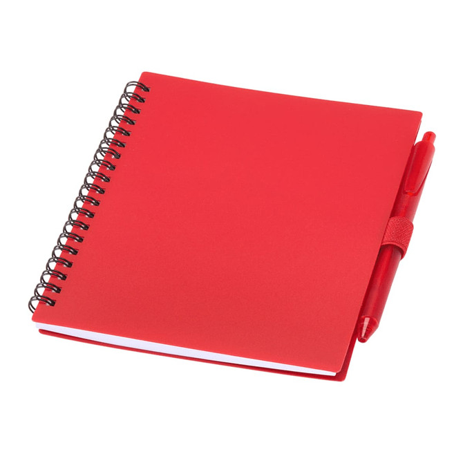 A red recycled polypropylene journal with a spiral binding and a matching red pen attached.