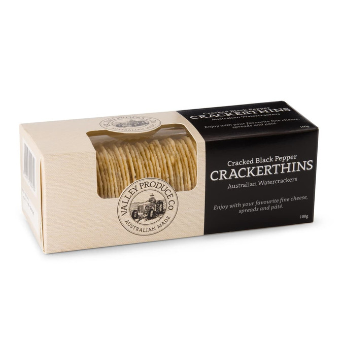 A box of Cracked Black Pepper Crackerthins featuring a stack of thin water crackers. The box has a logo and a beige colour scheme.