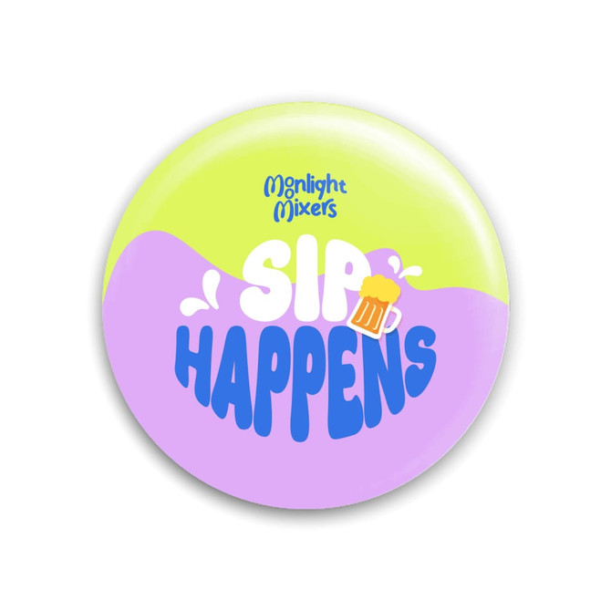 A drink bottle opener circular button in pastel purple and green, featuring a playful design and a logo.