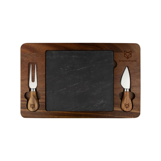 A slate cheeseboard with a wooden border and two cheese knives, featuring a logo. The board has a rectangular shape.