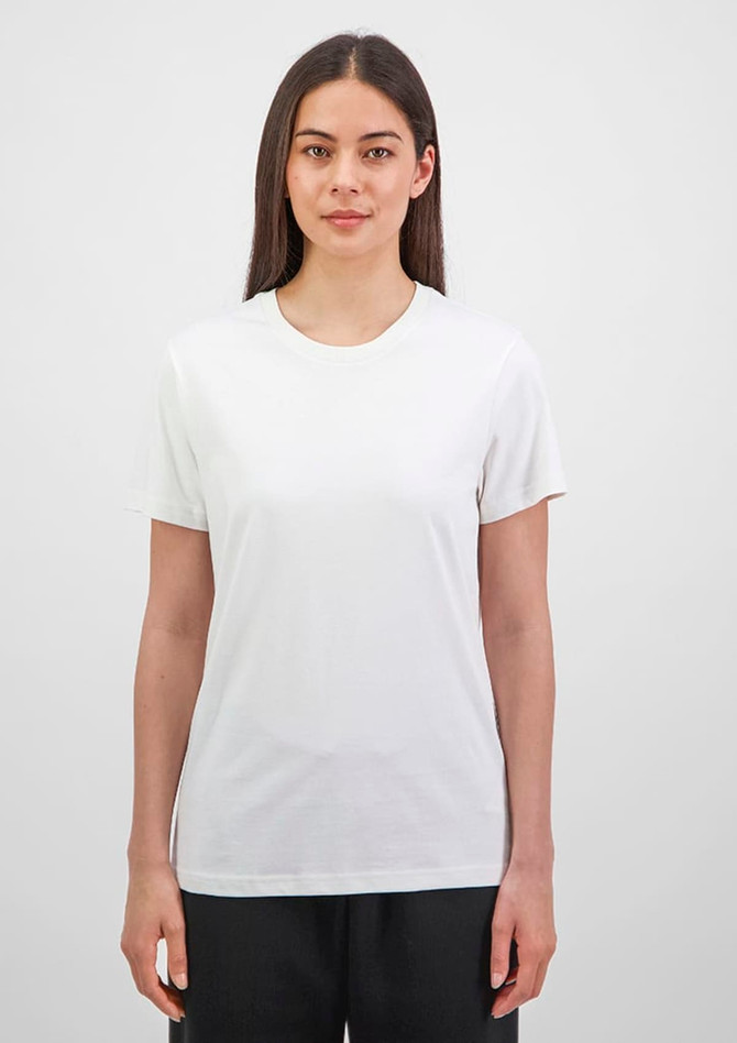 A short sleeve tee in white, featuring a crew neckline and a fitted style, displayed by a model.