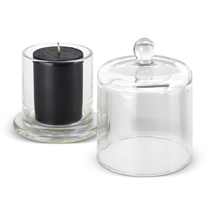 A black candle in a glass holder, accompanied by a clear glass cloche with a round knob on top.