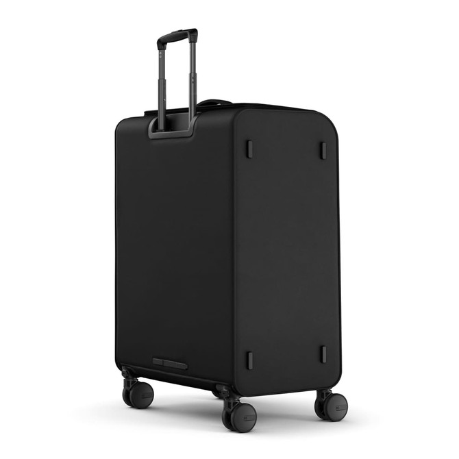 A black wheeled suitcase with a retractable handle and four wheels, featuring a sleek, minimalist design.