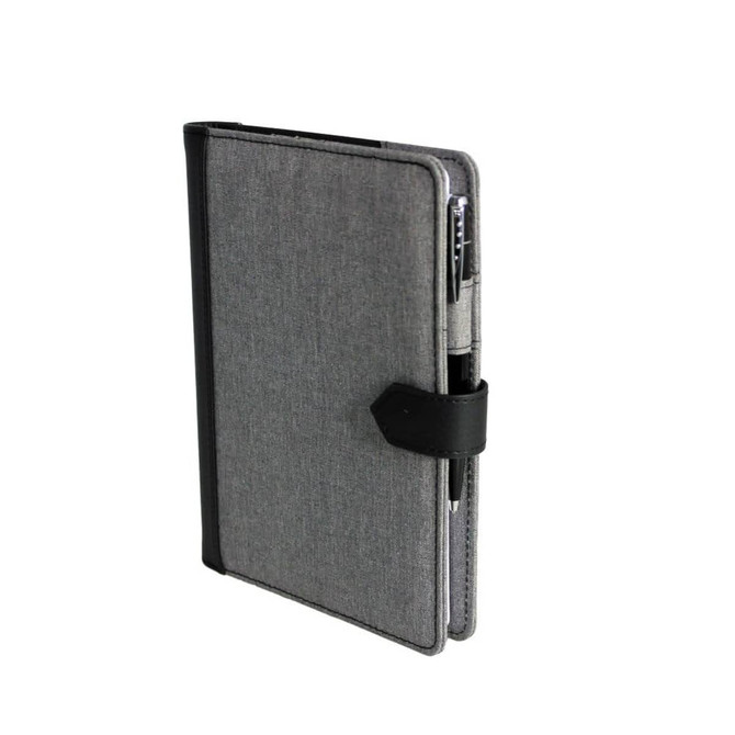 A grey journal book with a black strap and a pen attached, featuring a simple design and a logo on the cover.