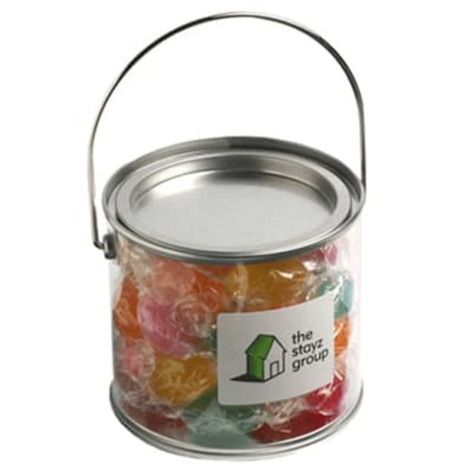 A medium clear PVC bucket filled with colourful boiled lollies, featuring a metal handle and a branding logo.