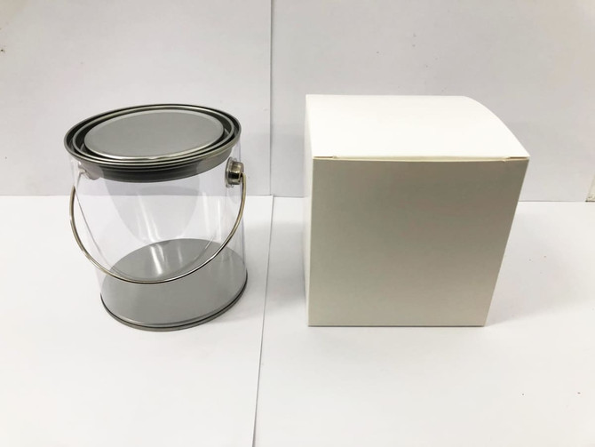 A clear PVC bucket with a silver lid, accompanied by a white box, intended for packaging confectionery.