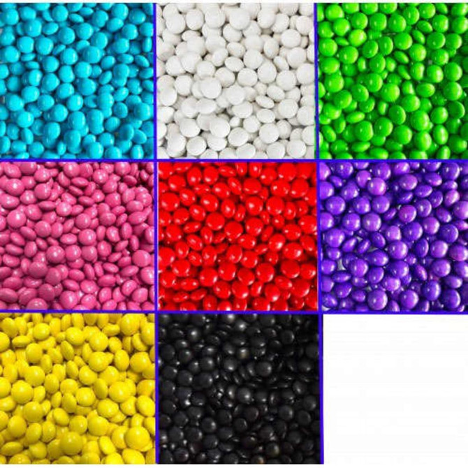 A jar filled with colourful choc beans in various shades, including blue, white, green, pink, red, purple, yellow, and black.