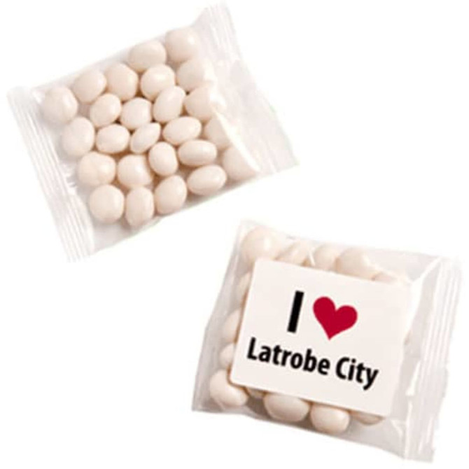 A clear bag containing chewy white mints, with an unbranded side and a logo featuring a heart and text.