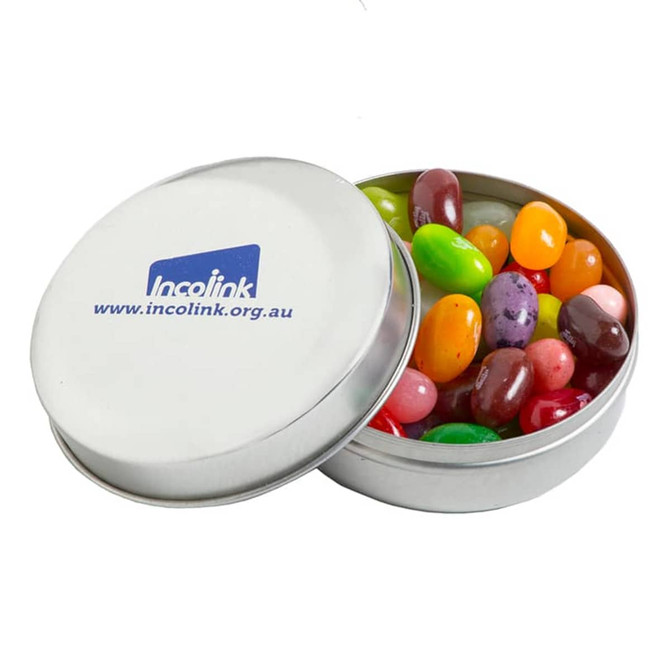 A tin container filled with colourful jelly beans, featuring a lid with a logo.