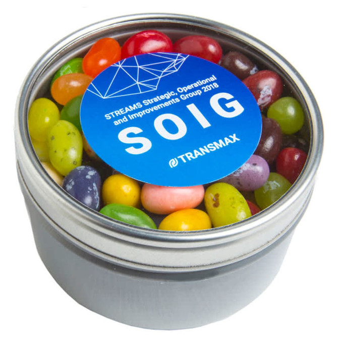 A small round acrylic tin filled with colourful JELLY BELLY jelly beans, featuring a logo on the lid.