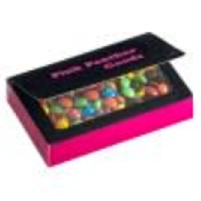 A box with a transparent lid filled with colourful chocolate beans, featuring a pink exterior and a branding logo.