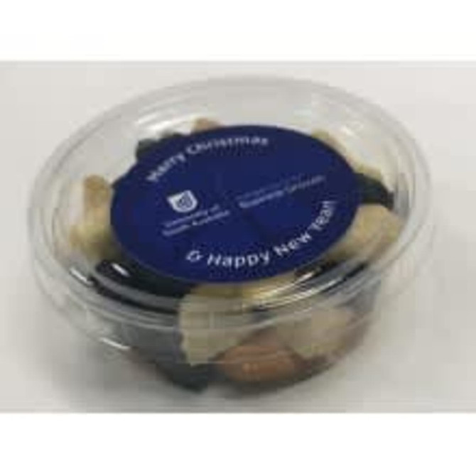 A clear tub filled with a mix of assorted nuts and dried fruit, featuring a blue lid and a label.