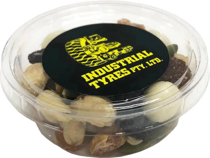 A clear tub filled with a variety of yoghurt-coated nuts and trail mix, featuring a black lid with a logo.