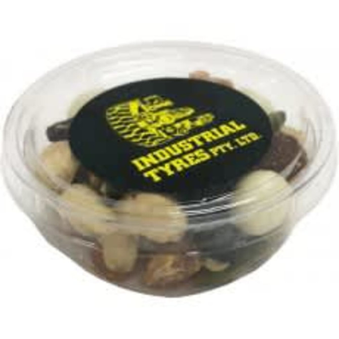 A clear tub filled with assorted yoghurt-coated nuts and trail mix, featuring a black lid with a logo.