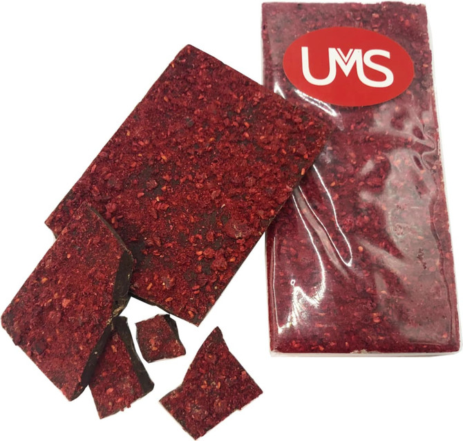 Premium chocolate bar with dried freeze raspberries, featuring a red and dark chocolate exterior, with pieces broken off.