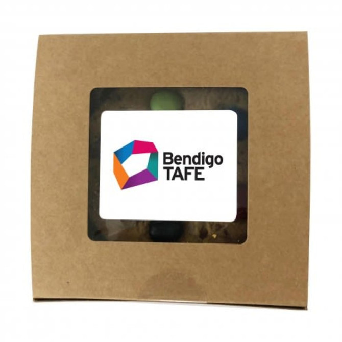 A window box of Cafe Style Cookies featuring a range of colourfully topped cookies and a logo on the sleeve.