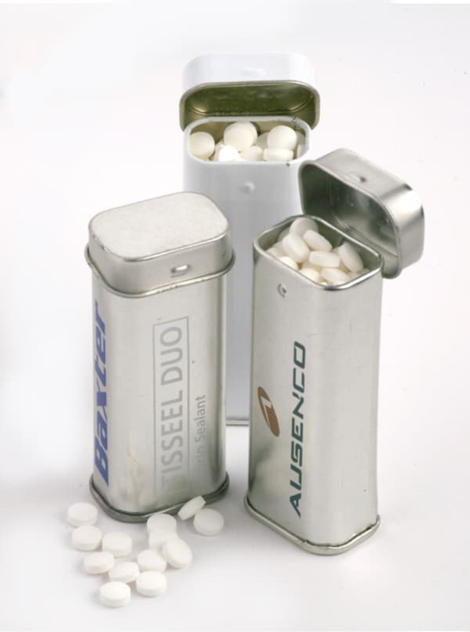 Three metal tins in silver, white, and aluminium containing round white mints. Each tin has a different logo.