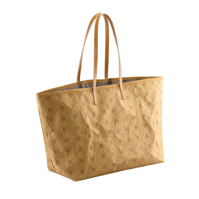 A yellow kraft paper tote bag with long handles and a logo pattern throughout.