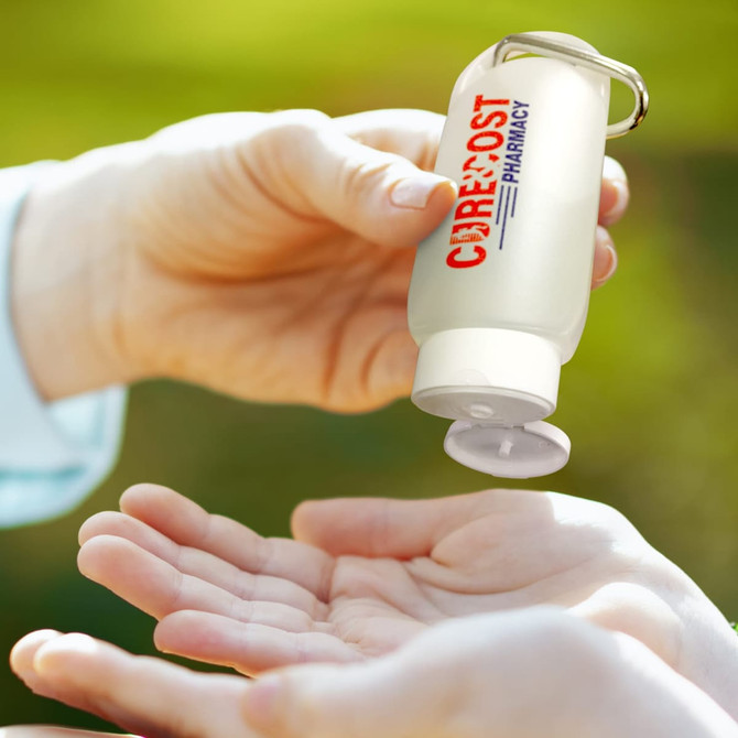 A clear 55ml gel hand sanitiser with a keychain lid is being poured into a hand. It has a logo on the bottle.