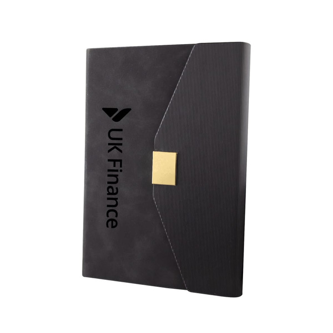 A sleek black notebook with a textured cover and a gold clasp, featuring a logo on the front.
