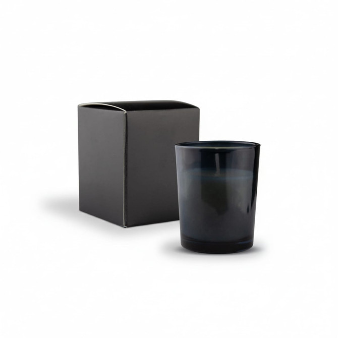 A dark blue glass candle in a box, with a minimalist design and a smooth finish. The box is black.