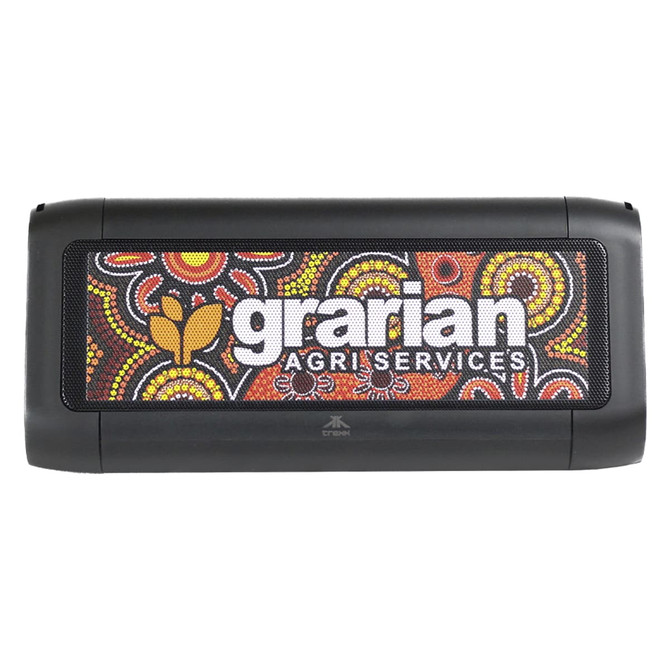 A black outdoor speaker featuring a vibrant Aboriginal art design and a logo. Suitable for outdoor use and charging devices.