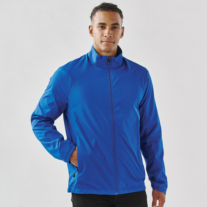 A blue full zip jacket with a collar, featuring a sleek design and side pockets, worn by a man.