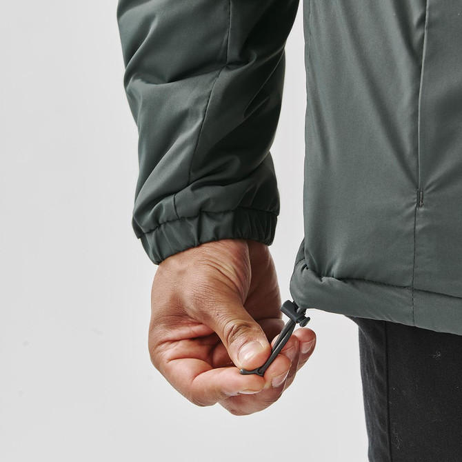 A hand adjusts the drawstring of a dark green thermal jacket, showcasing its elastic cuffs and sleek design.