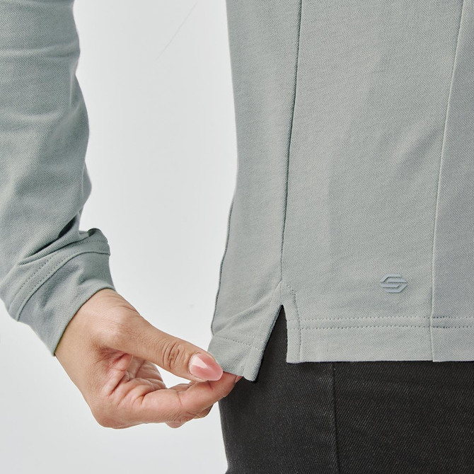 A light grey long sleeve polo shirt, featuring a side slit detail and a logo on the hem.