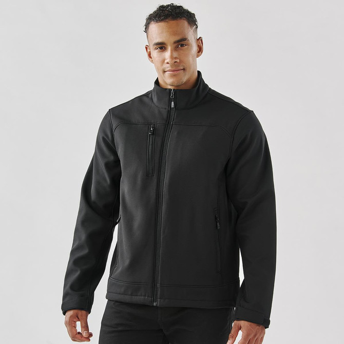 A black men's softshell jacket with a zip front, side pockets, and a chest pocket, featuring a logo.