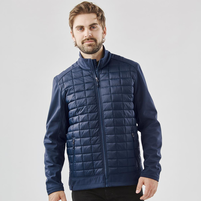 A men's navy softshell jacket with a quilted front and a straight zip closure, featuring a logo on the chest.