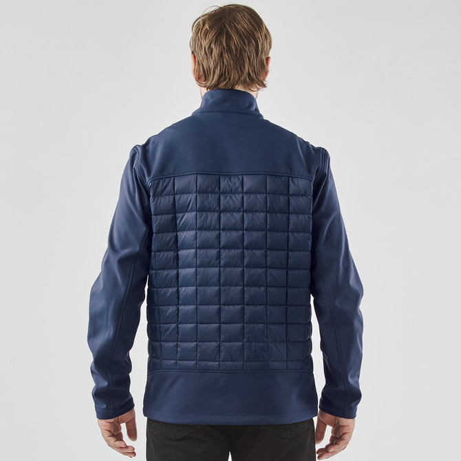 A navy blue men's softshell jacket with a quilted back and raised collar, featuring a logo on the upper left.