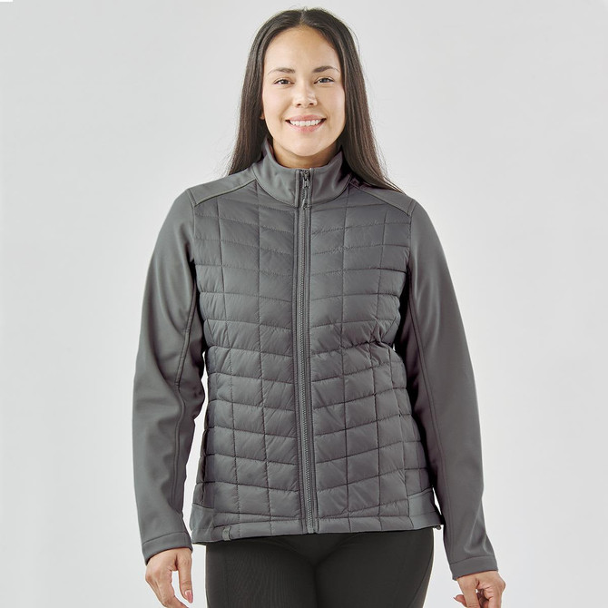 A grey women's softshell jacket with a quilted front and a zip-up design, featuring a logo on the chest.