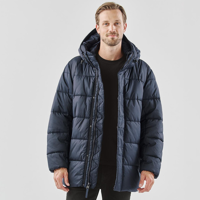 A navy blue puffer jacket with a hood, featuring a zip closure and a relaxed fit. It has a logo on the garment.