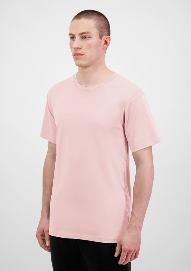 A light pink men's short sleeve t-shirt displayed on a model, featuring a plain design and a logo.