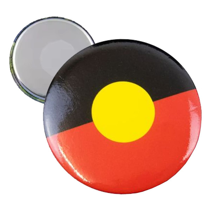 A round fridge magnet button badge featuring Aboriginal colours: black, red, and yellow with a shiny finish.