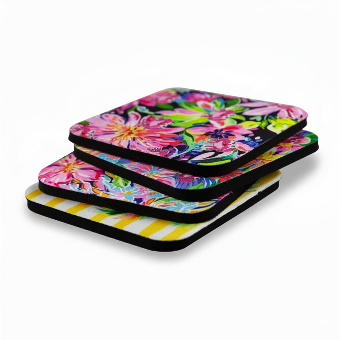 A set of vibrant 5mm neoprene coasters featuring floral designs and a striped pattern, with black edges.