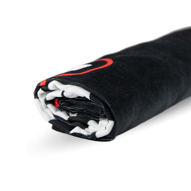 A rolled black beach towel featuring a logo, measuring 75cm x 150cm. The towel has a contrasting inner side.