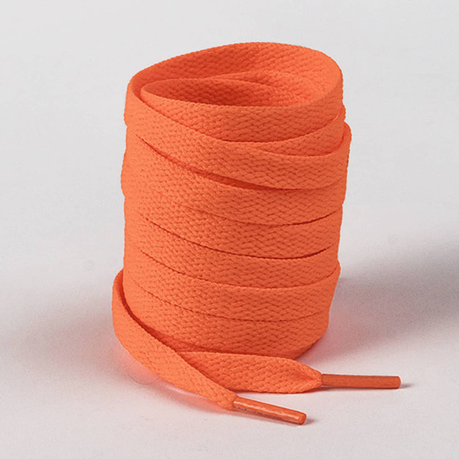 A bundle of bright orange shoelaces with flat woven texture and pointed tips.