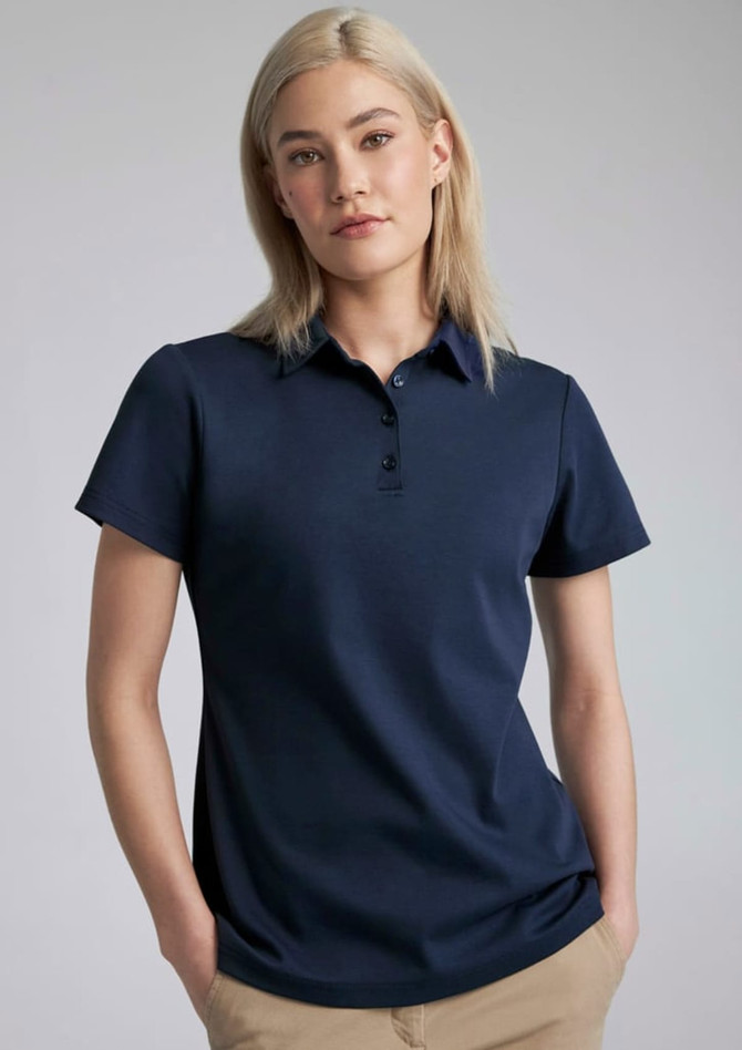 A navy women's short sleeve polo shirt featuring a collar and a logo.