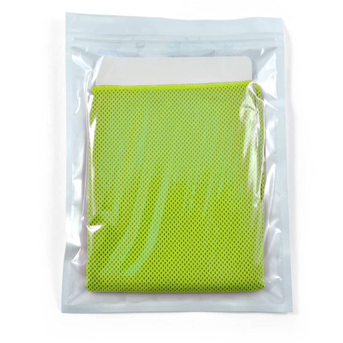 A green cooling towel neatly packaged in a transparent pouch, featuring a textured surface.