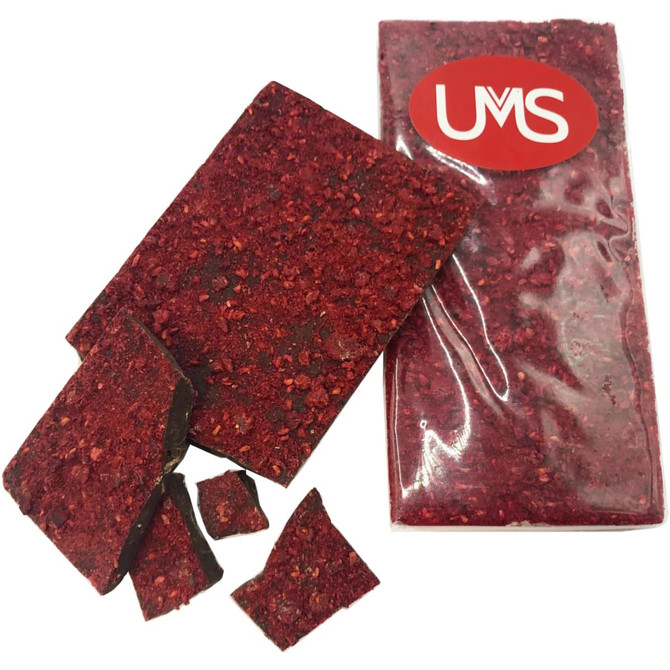 Premium chocolate-covered freeze-dried raspberries, in rich red and dark brown hues, with pieces scattered beside the packaged product.