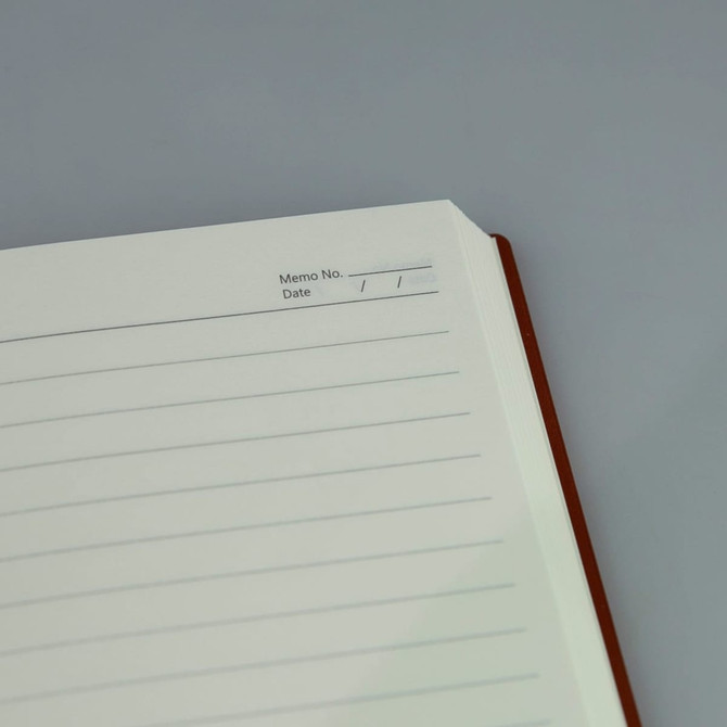 A brown A5 notebook with lined pages and a space for memo number and date at the top.