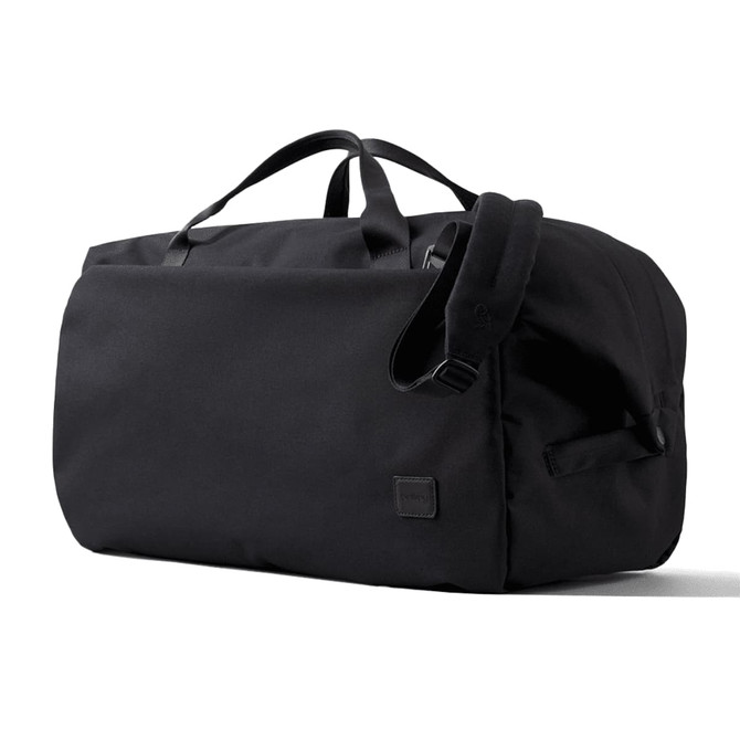 A black duffel bag with handles and an adjustable strap, featuring a small logo on the side.