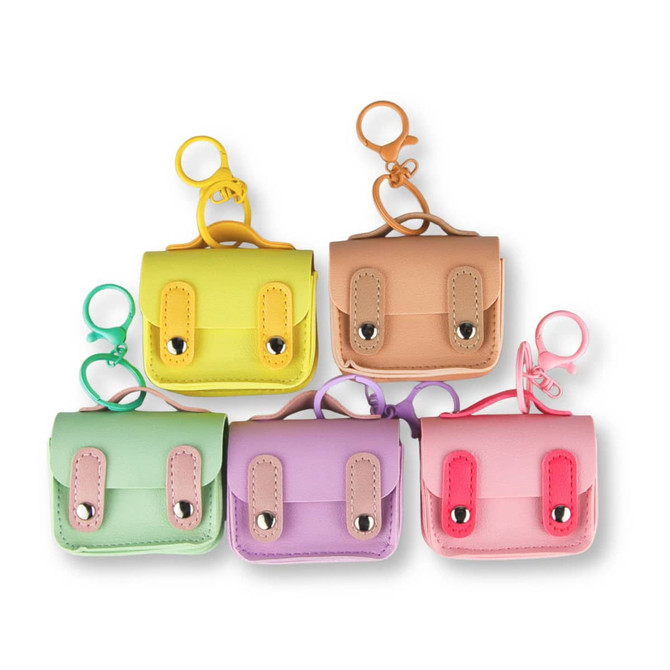 A collection of five small pastel-coloured charm cases, featuring yellow, peach, purple, pink, and green with keychain attachments.
