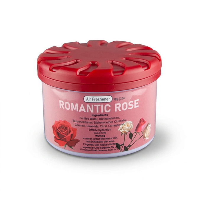 A round container of air freshener with a pink label featuring red and white roses and a red lid.